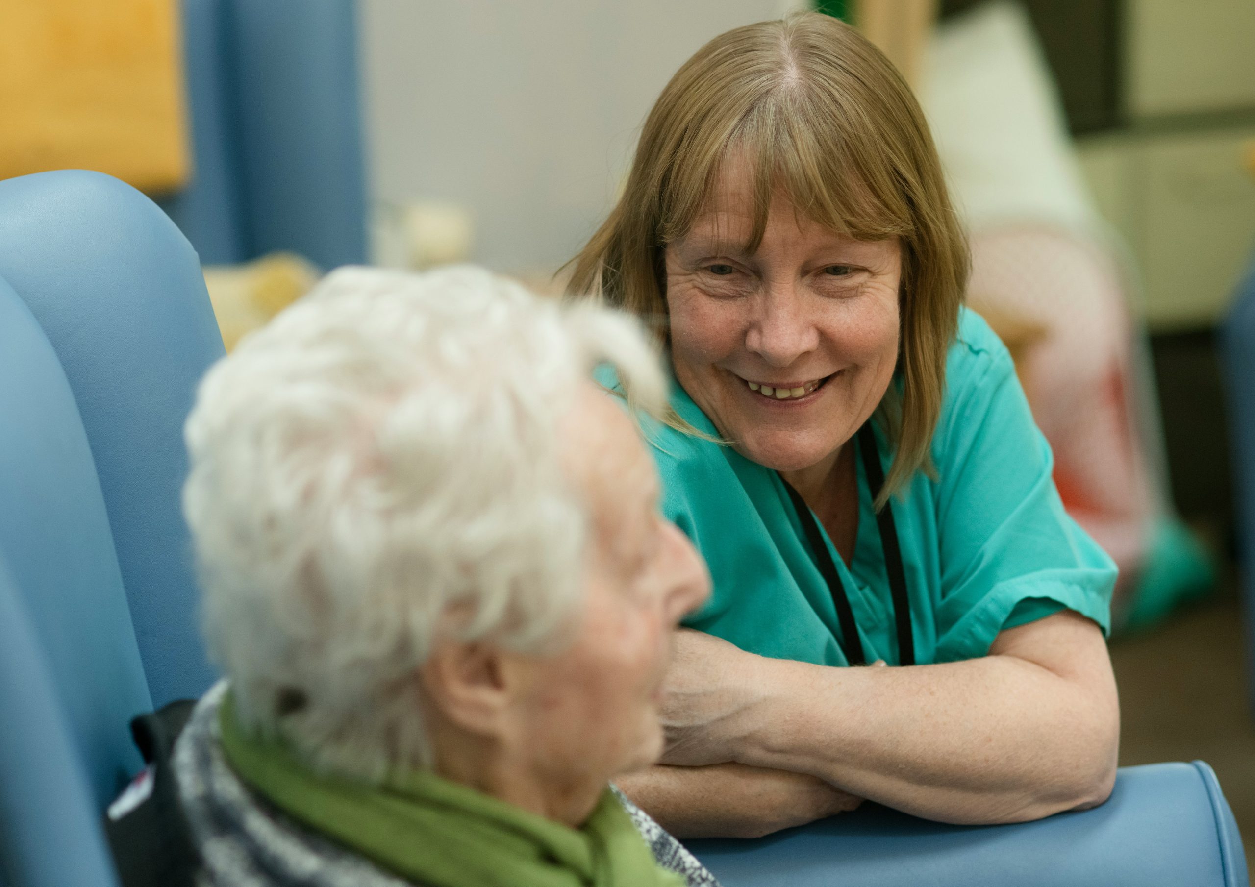 A woman meeting with an older woman in a long-term care community